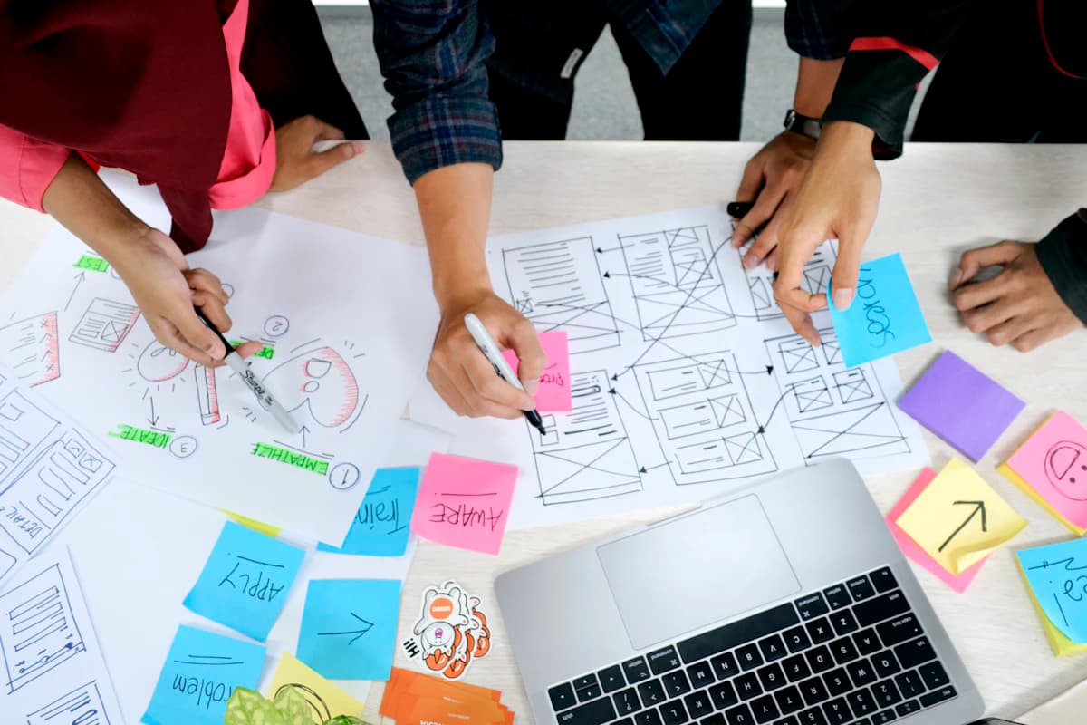 Designer sketching wireframes on paper